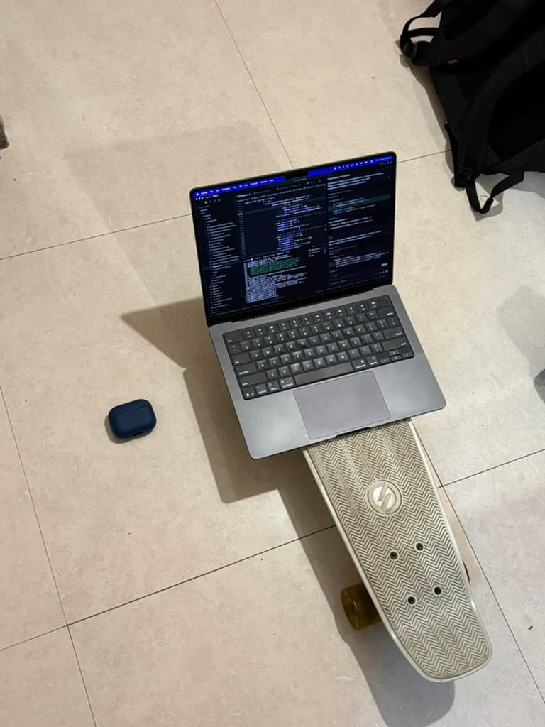 Working outdoors with a laptop and skateboard